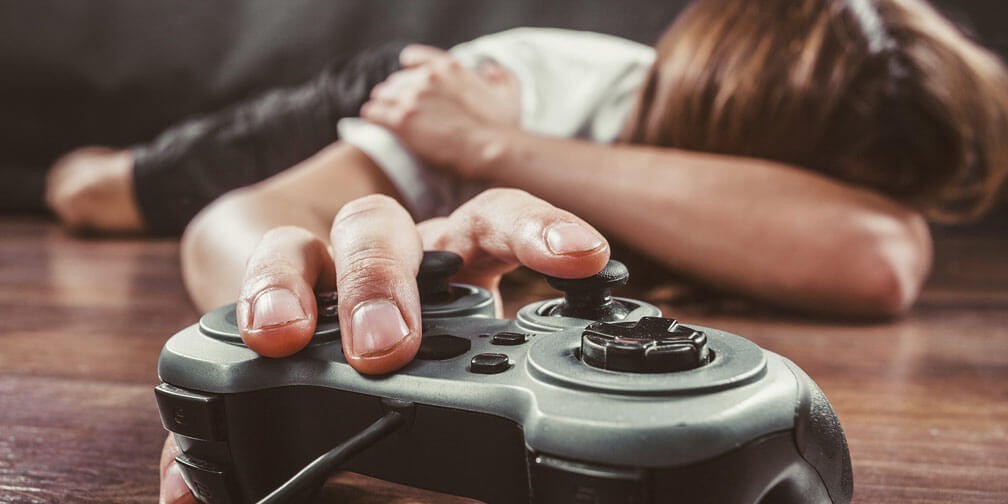 Addiction Boy holding game remote